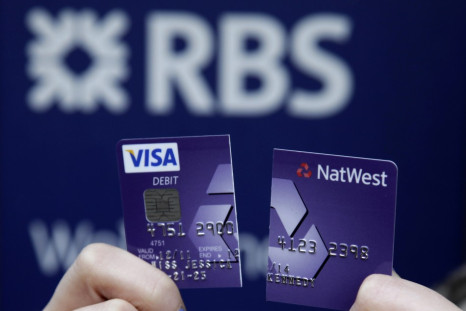 RBS-NatWest customer holds up debit card cut in half to demonstrate dissatisfaction with service following computer glitch