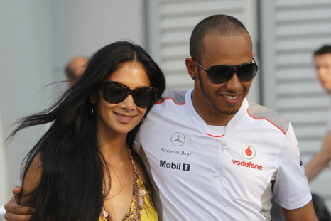 McLaren Formula One driver Hamilton walks with his girlfriend Nicole after the qualifying session of the Malaysian F1 Grand Prix at Sepang International Circuit outside Kuala Lumpur