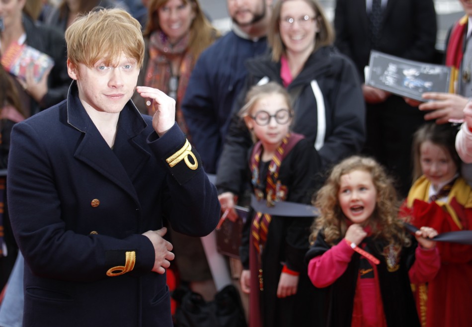 Actor Rupert Grint is cheered by young fans as he arrives at the opening of the Warner Brothers Studio Tour- The Making of Harry Potter north London