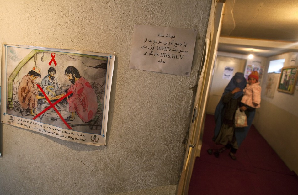 A drug addict holds her child as she visits the Nejat drug rehabilitation centre, an organisation funded by the United Nations providing harm reduction and HIVAIDS awareness, in Kabul