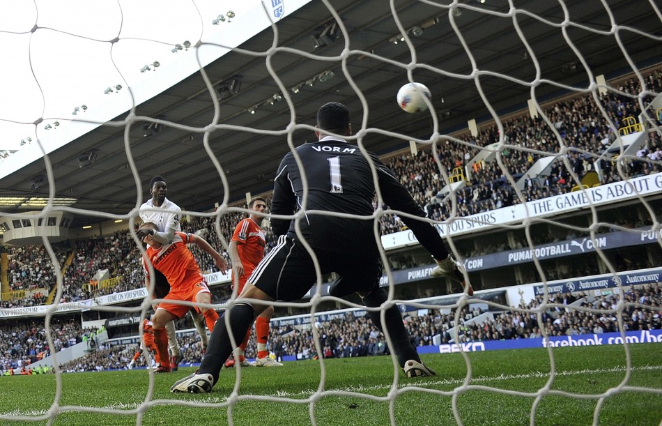 Tottenham Hotspur039s Emmanuel Adebayor rises above Swansea City039s Gary Monk to score his second goal during ttheir English Premier League soccer match in London