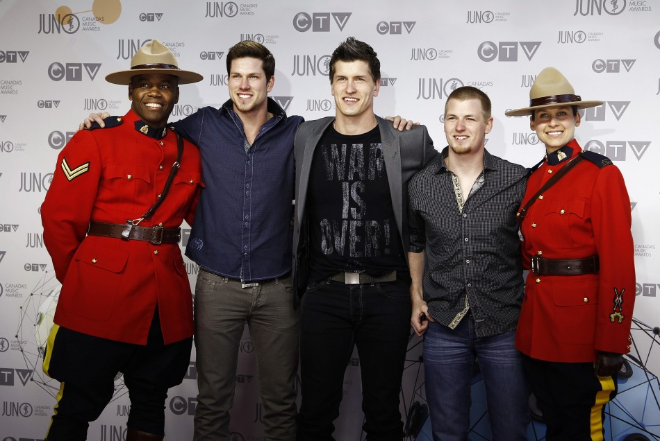 Members of the band High Valley pose with Royal Canadian Mounted Police officers during the 41st Juno Awards in Ottawa