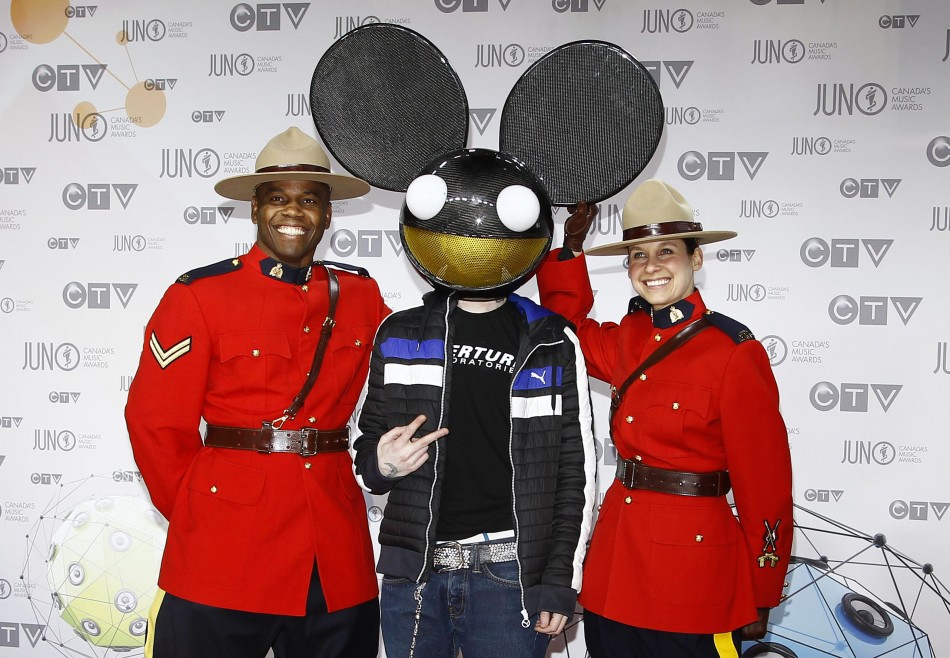 Recording artist deadmau5 poses with Royal Canadian Mounted Police officers during the 41st Juno Awards in Ottawa