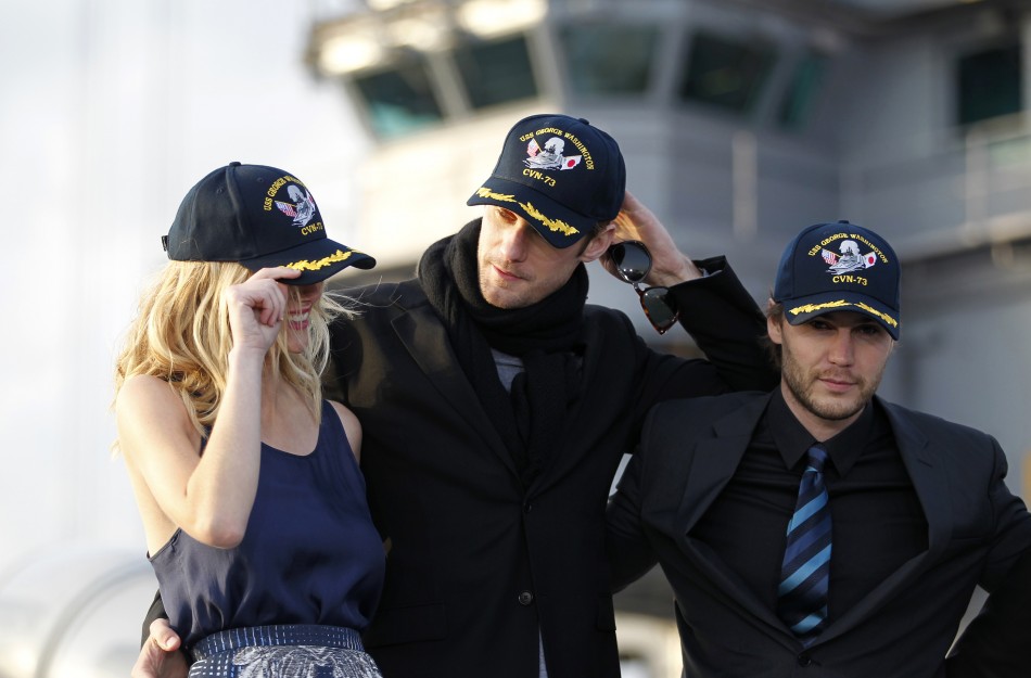 Cast members of the film quotBattleshipquot wear caps during a news conference atop a flight deck of aircraft carrier USS George Washington at Yokosuka port, south of Tokyo