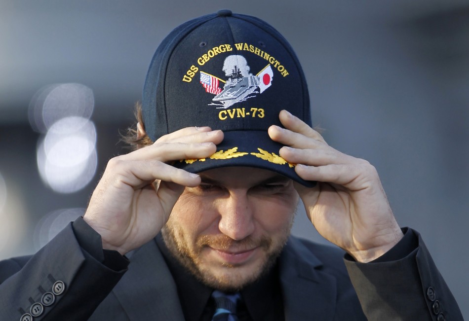 Actor Taylor Kitsch wears a cap during a news conference to promote his film quotBattleshipquot atop a flight deck of aircraft carrier USS George Washington at Yokosuka port, south of Tokyo