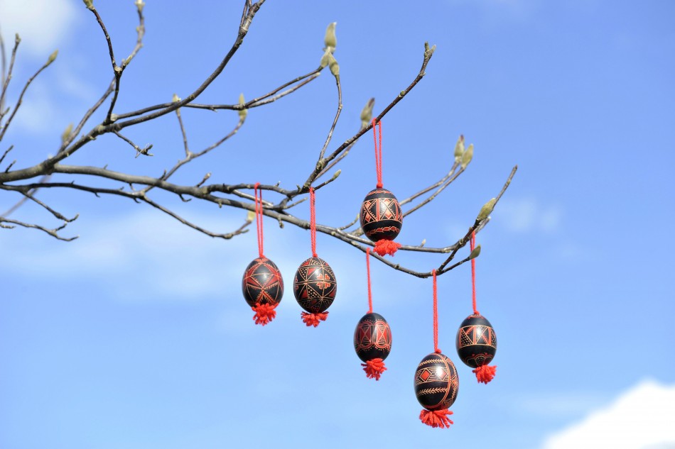 Decorated Easter eggs are seen hanging from a tree in Adlesici
