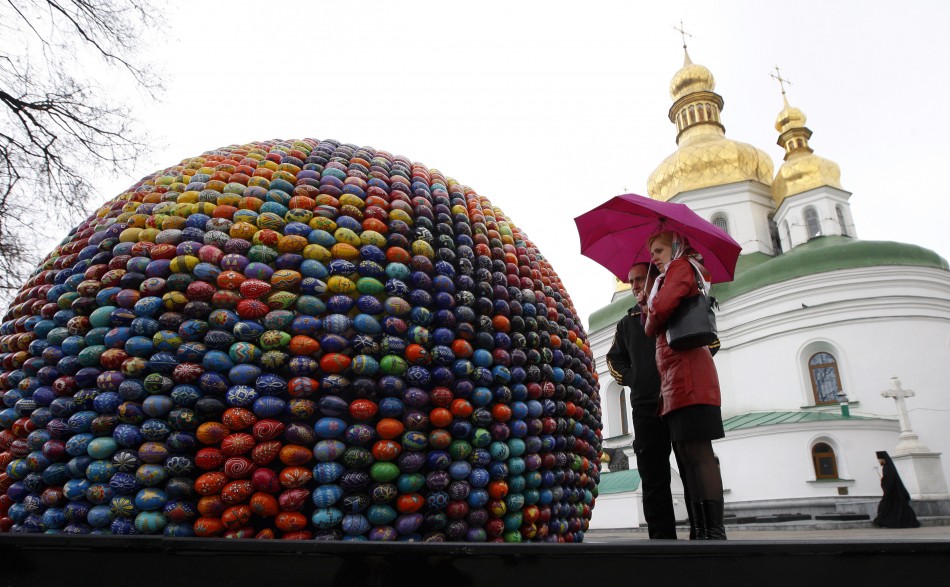 People look at a sphere sculpture made from Easter eggs on the day of its unveiling at Kievo-Pecherskaya Lavra cathedral in Kiev