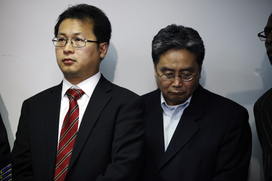 Hyok-in Kwon and Kyung Kim of the Korean United Methodist Church attend a news conference at the Oakland Police Headquarters after a shooting incident at Oikos University in Oakland