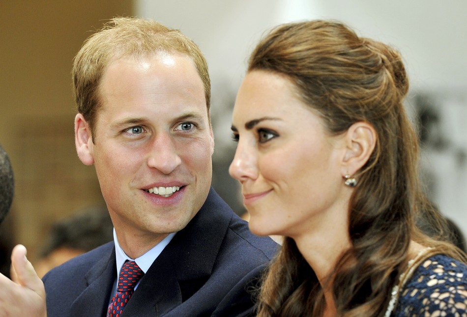 Britains Prince William looks at his wife, Catherine, the Duchess of Cambridge, during their visit to the Inner City Arts club in Los Angeles