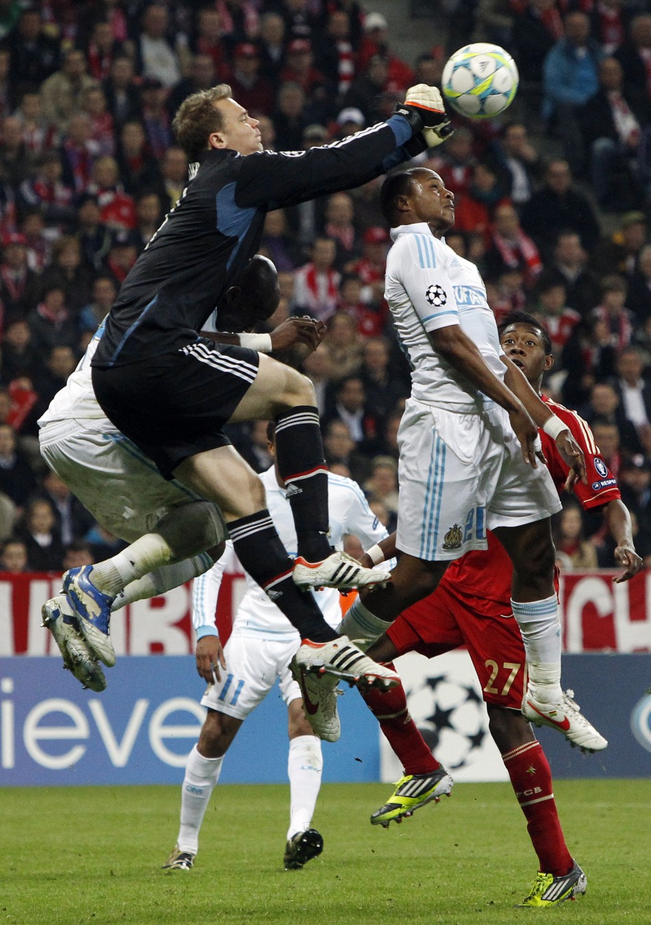 Bayern Munich039s goalkeeper Neuer saves ball against Olympique Marseille039s Ayew during Champions League quarter-final soccer match in Munich