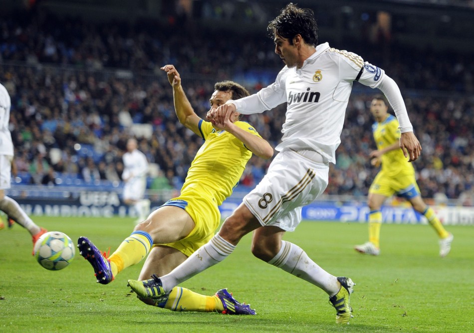 Real Madrid039s Kaka and APOEL039s Manduca challenge for the ball during their Champions League quarter-final second leg soccer match in Madrid
