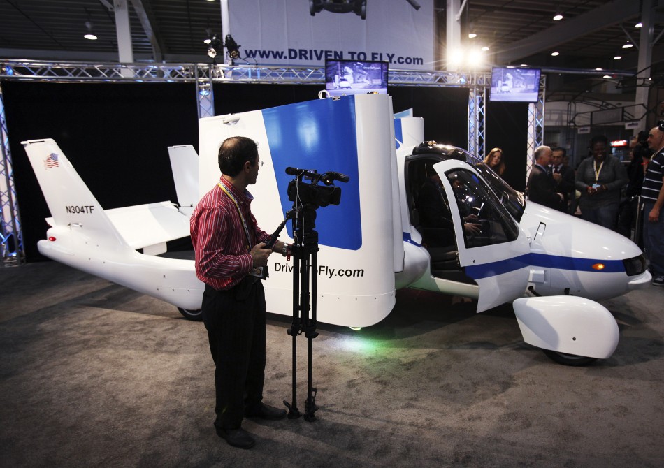 A man films aircraft company Terrafugias flying car, called the Transition, at the 2012 International Auto Show in New York