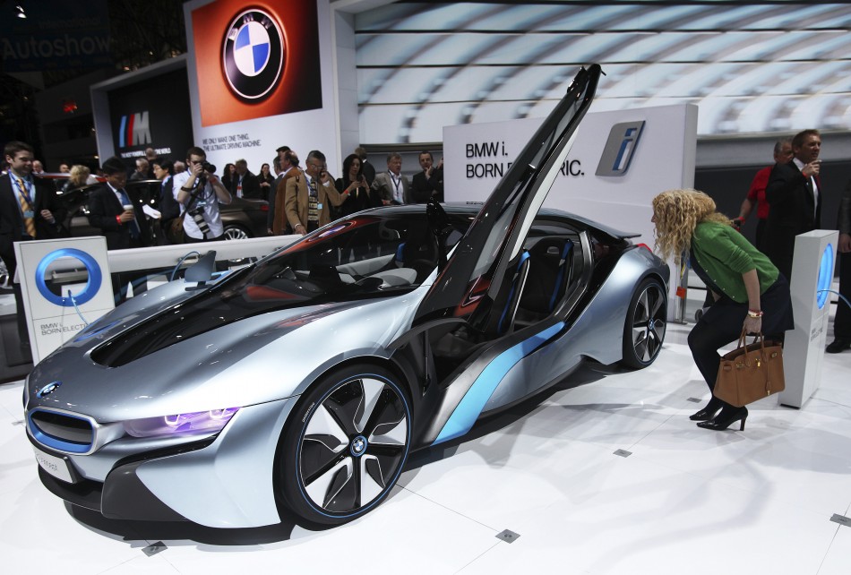 A visitor looks at the BMW i8 plug-in hybrid automobile at the 2012 International Auto Show in New York