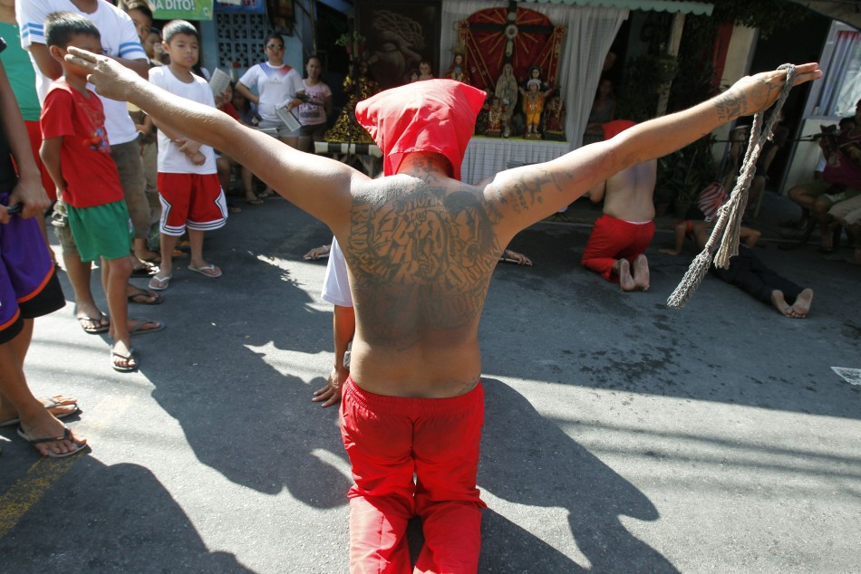 A penitent prays before whipping his back during Maundy Thursday Lenten rites in Mandaluyong city, metro Manila
