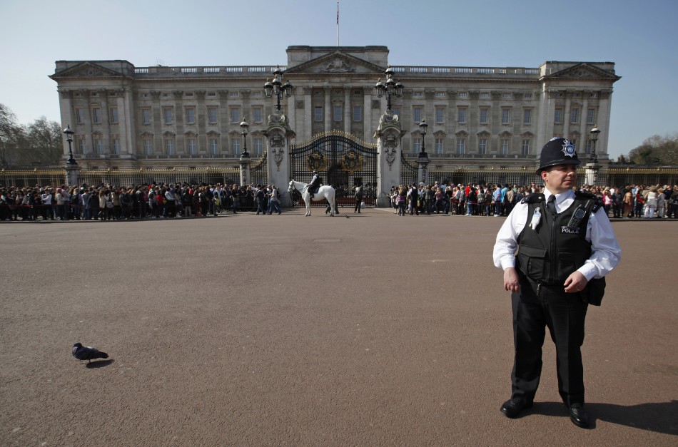 A police officer watches the crowd in front of Buckingham Palace