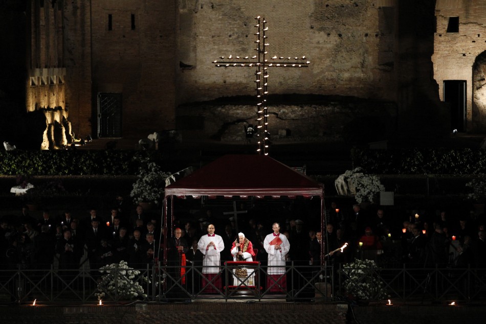 Pope Benedict XVI holds the cross as he leads the Via Crucis Way of the Cross procession at the Colosseum in downtown Rome