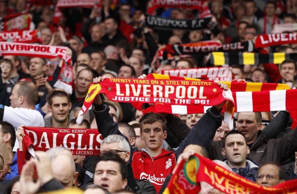 Liverpool fans hold up scarfs before their English Premier League soccer match against Aston Villa in Liverpool