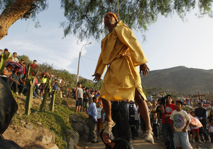 A penitent dressed as Judas is suspended from a tree in a re-enactment of the crucifixion of Jesus Christ on Good Friday in Comas, northern Lima, April 6, 2012.