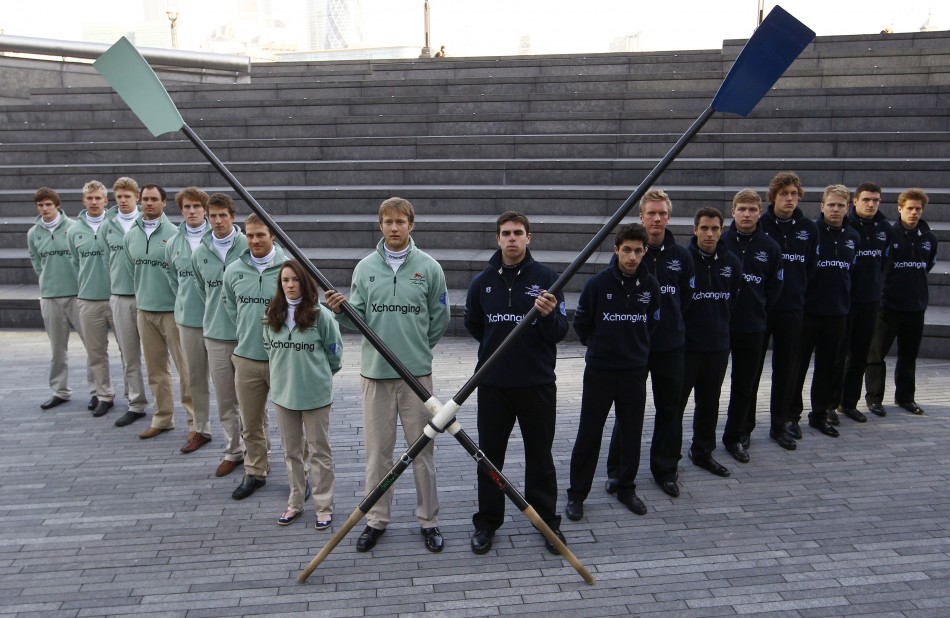 The Cambridge and Oxford boat crews pose for a photograph outside City Hall in London