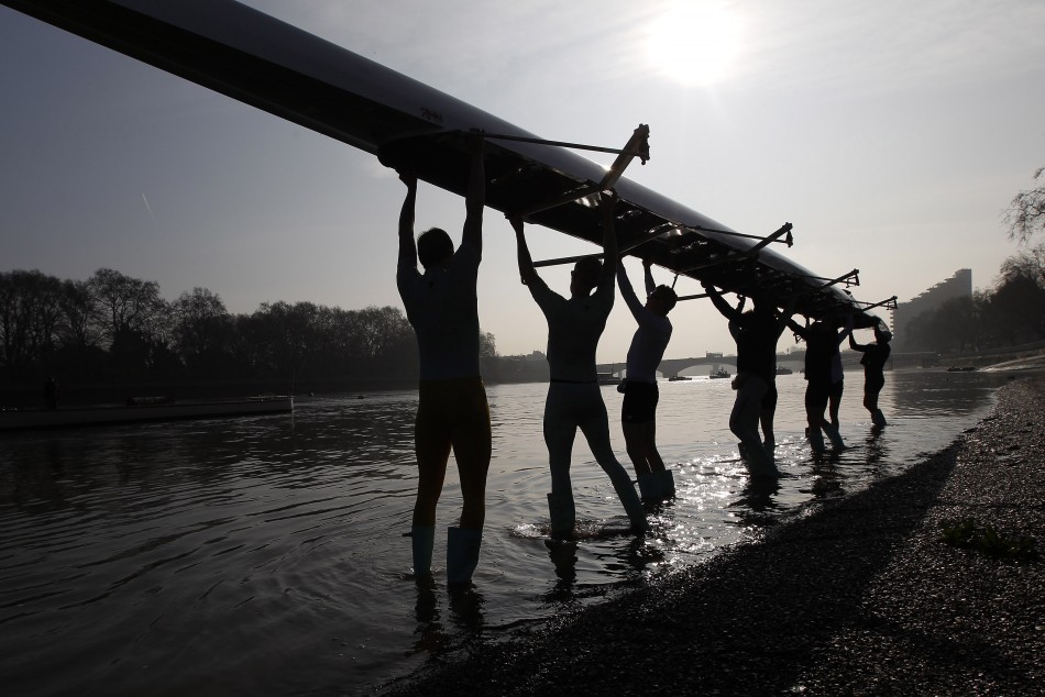 The Cambridge University rowing crew prepare for a training session on the River Thames in London