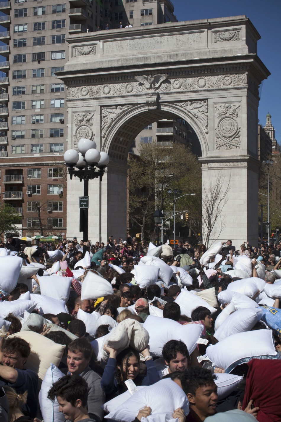 People participate in International Pillow Fight Day at Washington Square Park in New York