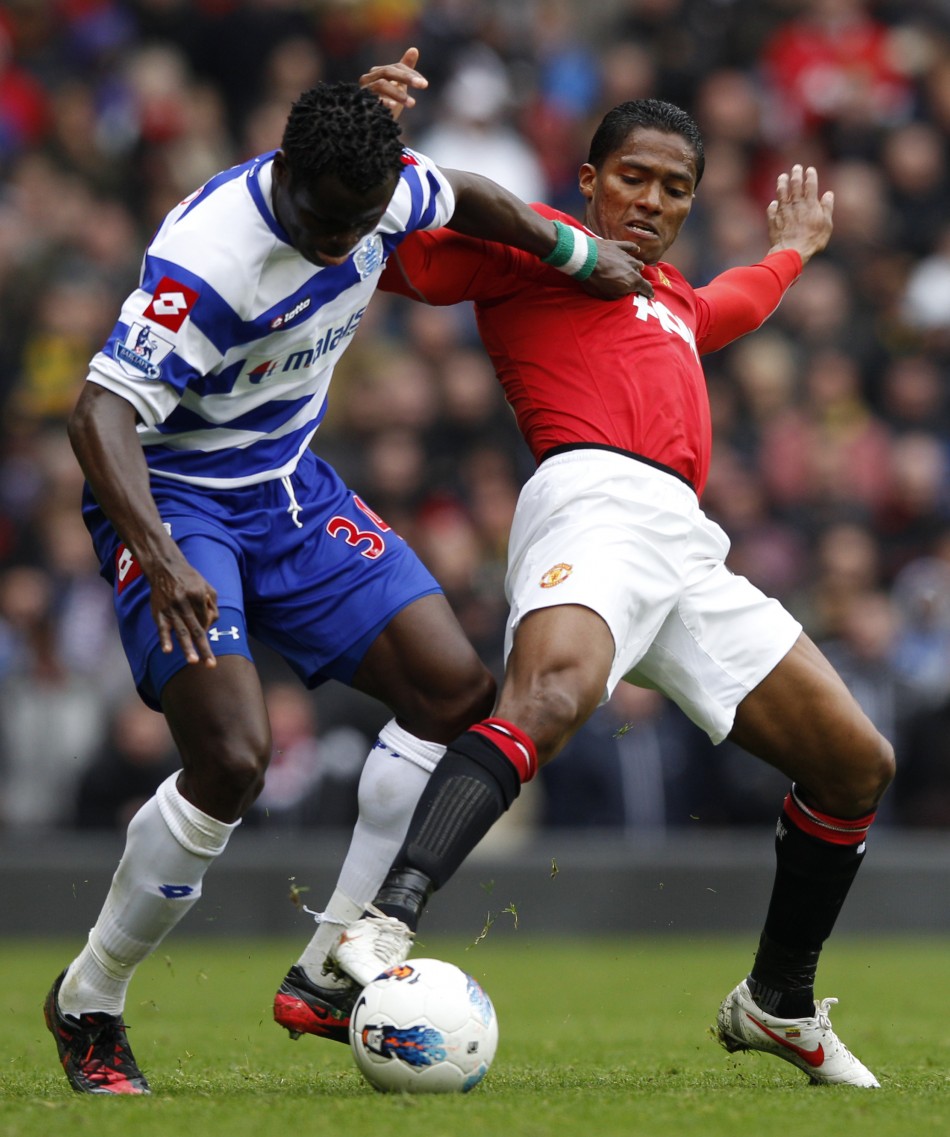 Queens Park Rangers039 Taiwo challenges Manchester United039s Valencia during their English Premier League soccer match in Manchester