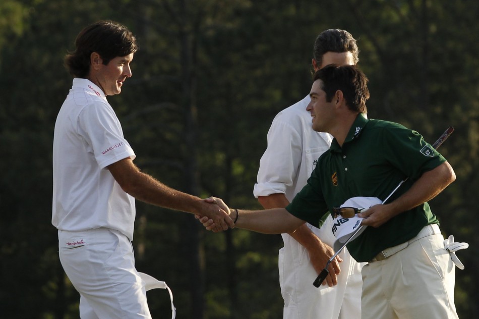 Watson of the U.S. shakes hands with Oosthuizen of South Africa after finishing their regulation round tied during final round play in the 2012 Masters Golf Tournament in Augusta