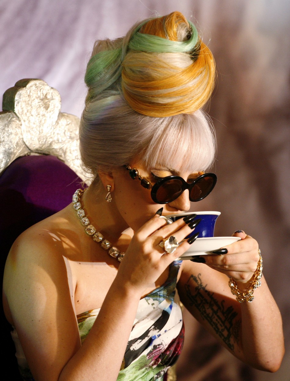 U.S. singer Lady Gaga sips a drink during a news conference in New Delhi