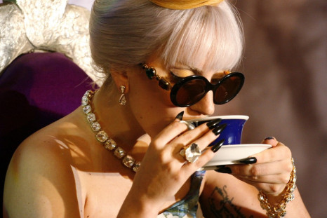 U.S. singer Lady Gaga sips a drink during a news conference in New Delhi