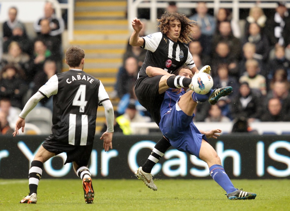 Newcastle United039s Coloccini tackles Bolton Wanderers039 Davies during their English Premier League soccer match in Newcastle