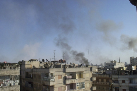 Smoke rises from the Al Qusoor district of Homs