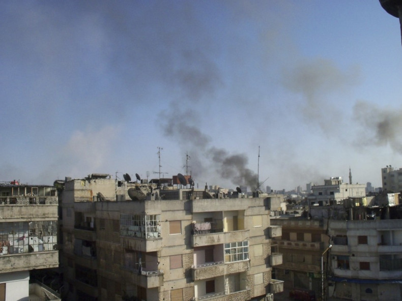 Smoke rises from the Al Qusoor district of Homs