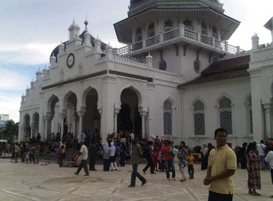 People gather outside the Baiturrahman mosque after an earthquake hit Banda Aceh