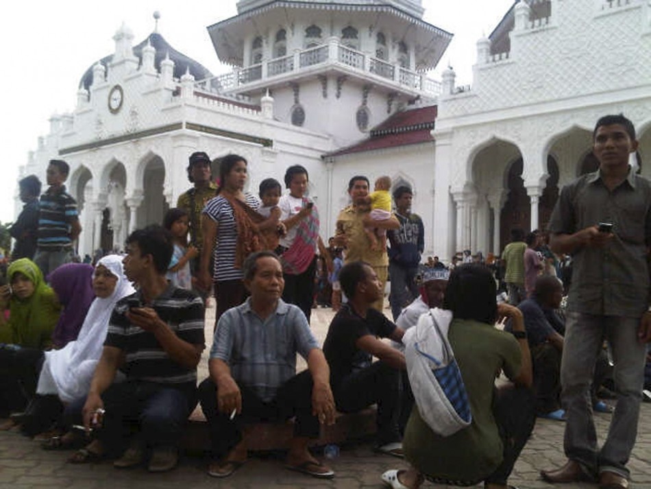 People gather outside the Baiturrahman mosque after an earthquake hit Banda Aceh
