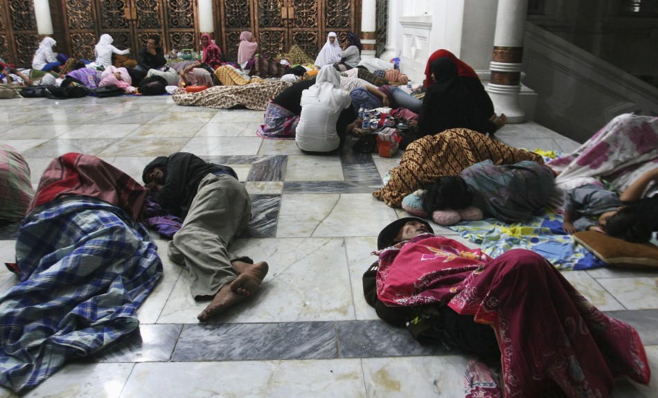 Residents sleep on the floor of Baiturrahman Mosque after an earthquake hit Banda Aceh