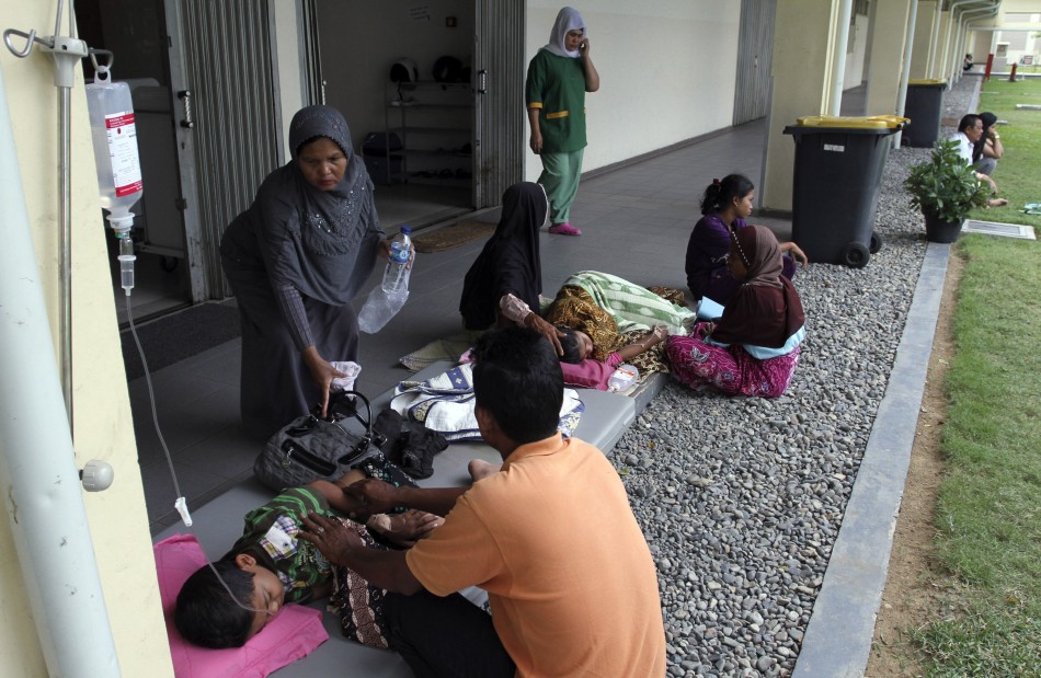 Patients rest in a corridor of a hospital after being evacuated from the hospital building in Banda Aceh, after an earthquake hit the western coast of Sumatra