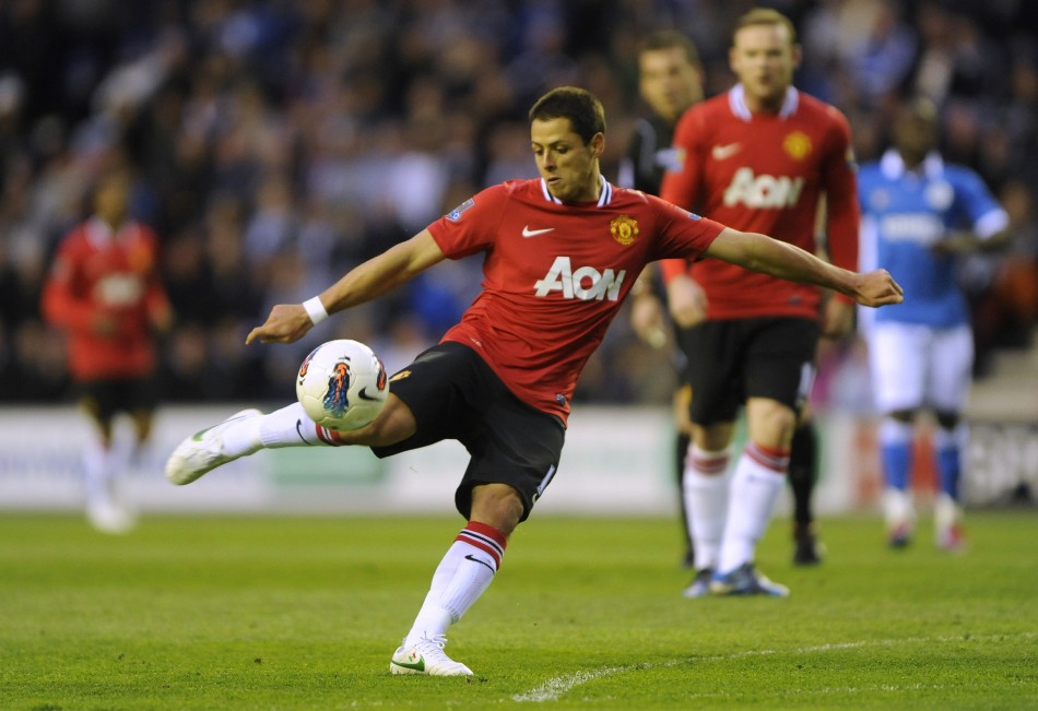 Manchester United039s Hernandez shoots against Wigan Athletic during their English Premier League soccer match at the DW Stadium Wigan
