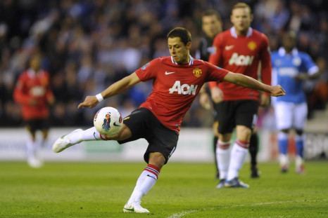 Manchester United&#039;s Hernandez shoots against Wigan Athletic during their English Premier League soccer match at the DW Stadium Wigan