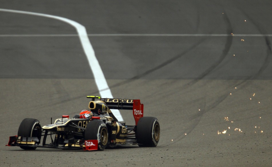 Sparks fly behind Lotus F1 Formula One driver Grosjean as he drives during the second practice session of the Chinese F1 Grand Prix at Shanghai circuit