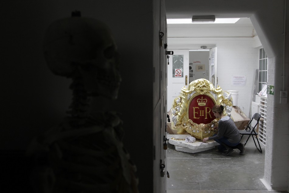 A City and Guilds student works on one of the decoration for the Diamond Jubilee Pageant Royal Barge at the London Art School in London