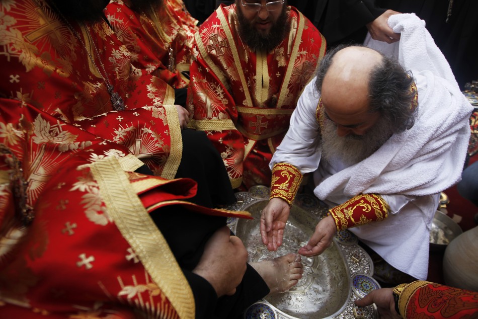 Greek Orthodox Patriarch of Jerusalem Theophilos washes the foot of a priest .