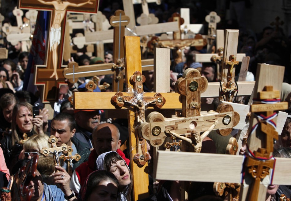 Christian worshippers carry crossesin the Old City of Jerusalem