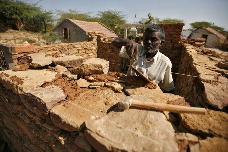 Bhai, an earthquake survivor, builds his house that was destroyed by the 2001 earthquake, at Rapar village in the western Indian state of Gujarat