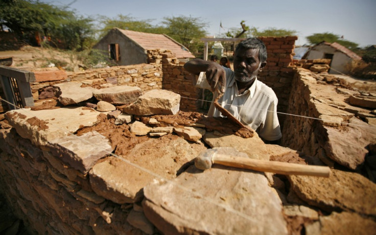 Bhai, an earthquake survivor, builds his house that was destroyed by the 2001 earthquake, at Rapar village in the western Indian state of Gujarat