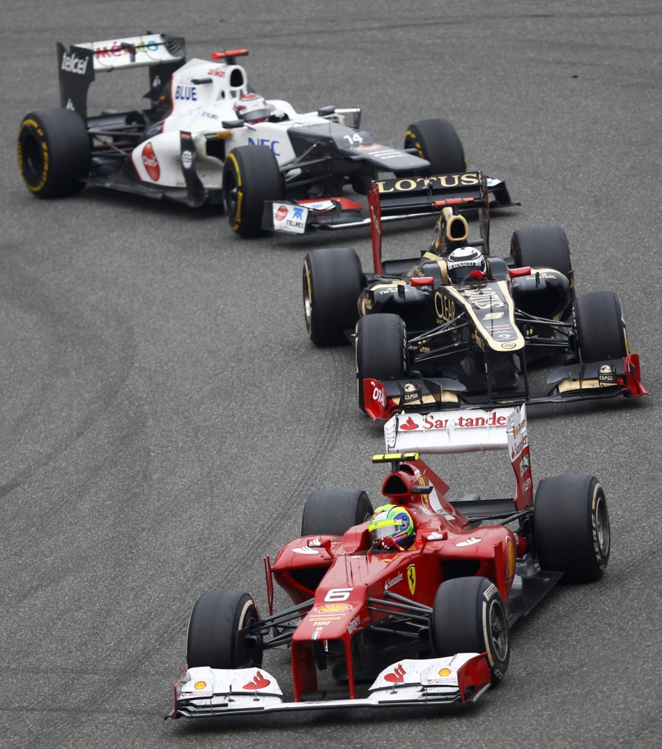 Ferrari Formula One driver Massa leads Lotus F1039s Raikkonen and Sauber039s Kobayashi during the Chinese F1 Grand Prix at Shanghai circuit