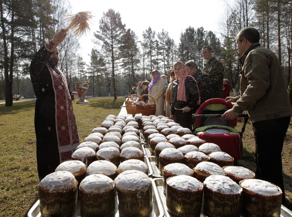 An Orthodox priest blesses Easter cakes during an Easter service at a military base near village of Okolitsa