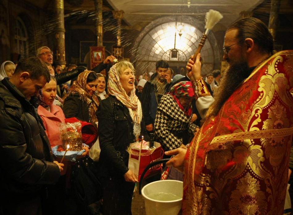 A priest blesses worshipers during an Orthodox Easter service at Kievo-Pecherskaya Lavra cathedral in Kiev