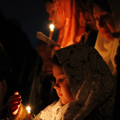 Russian Orthodox Old Believers hold candles during an Easter service at a church in Moscow