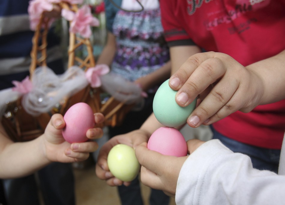 Iraqi Christian children break the painted eggs they received during celebrations after an Easter service at Chaldean Catholic church in Amman