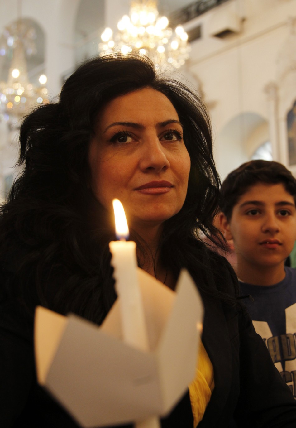 A Syrian woman attends a mass of an Orthodox Easter at the Roman Orthodox patriarchate in Damascus